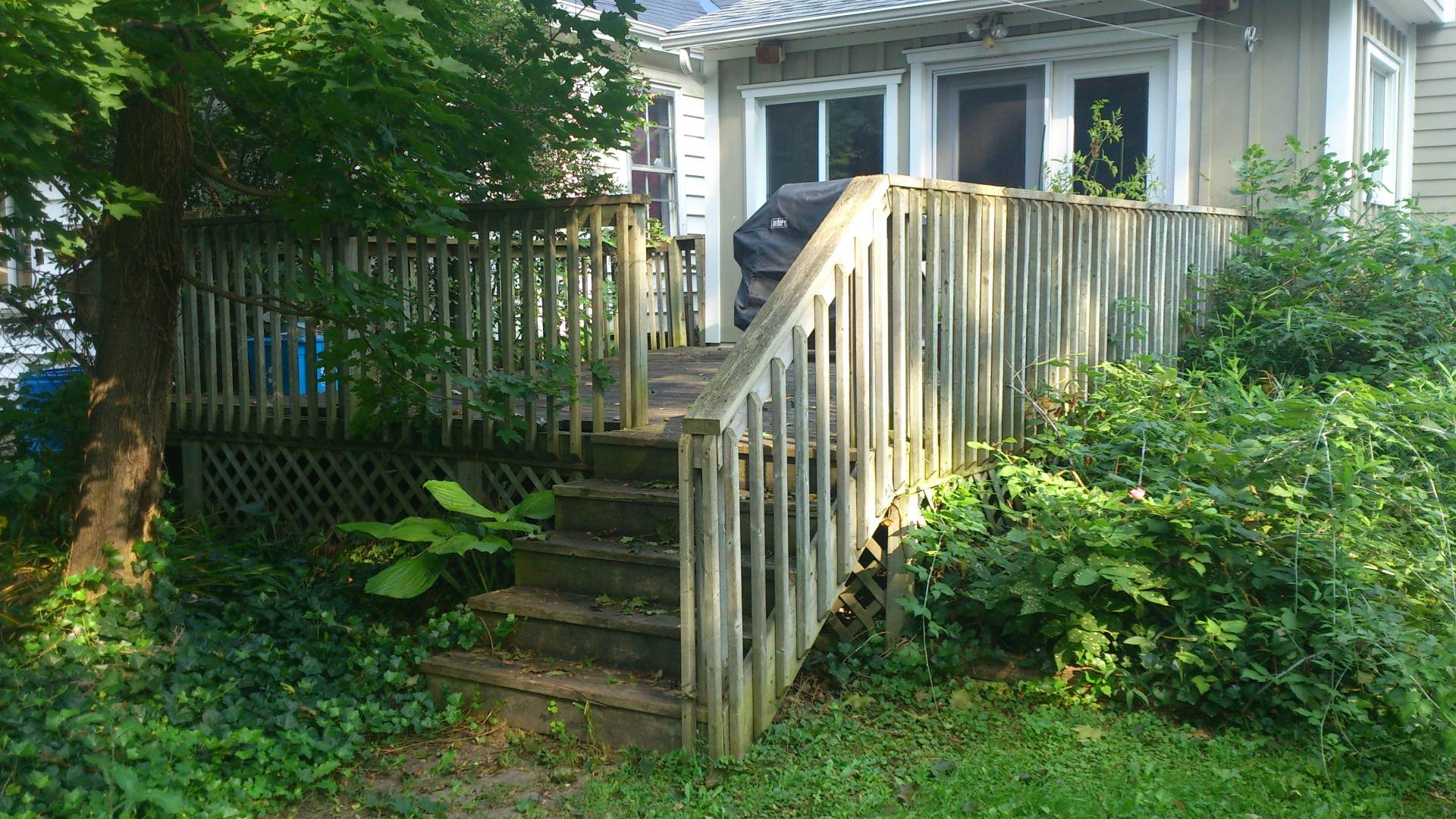 A before photo: backyard and deck renovation, a landscaping and deck woodwork project in London Ontario.