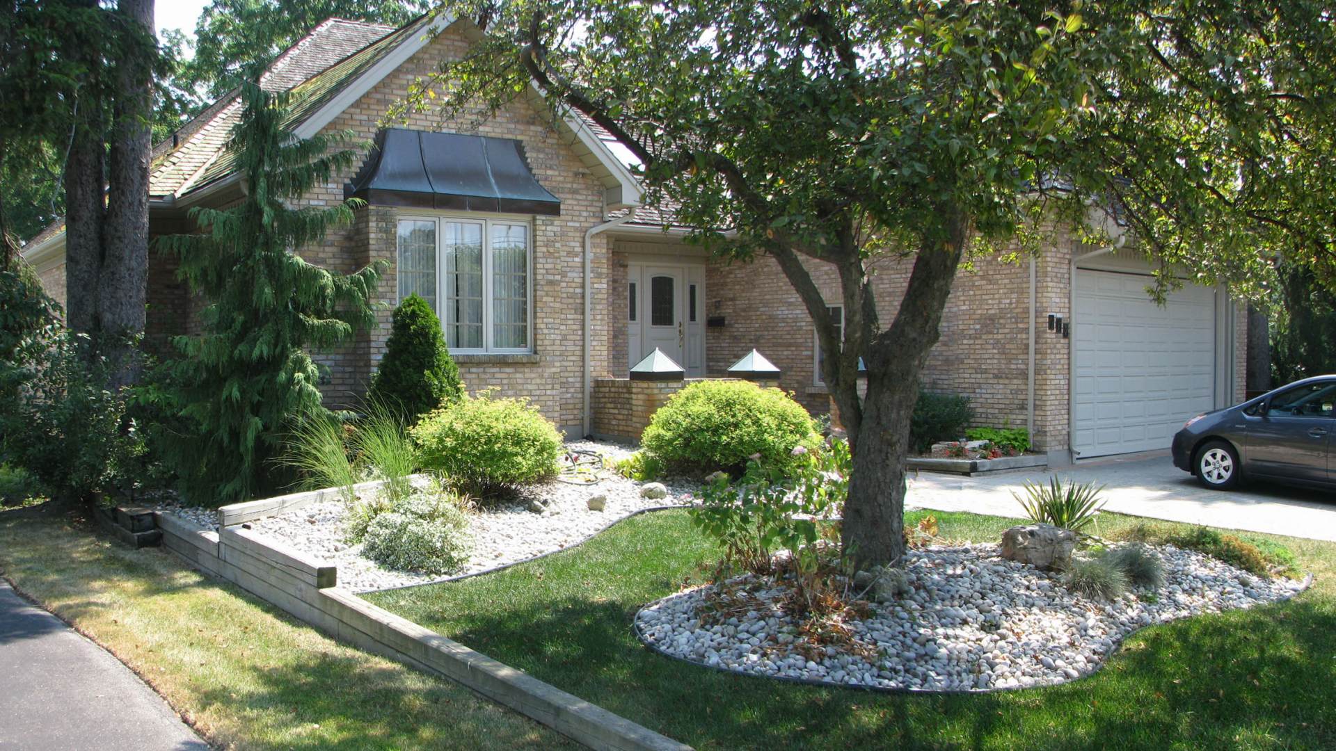 Before photo: front yard landscape redesign. A landscaping project in London Ontario.
