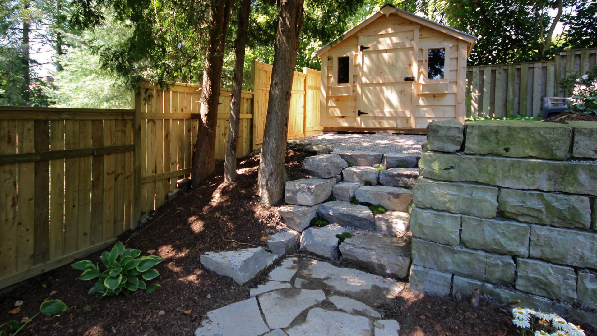 An after photo: landscaping / hardscaping project in London Ontario: natural stone steps.